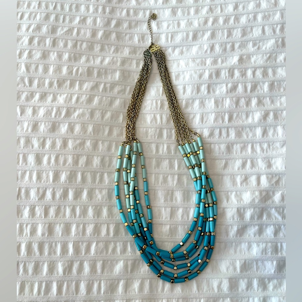 Turquoise necklace with gold accents in good condition.